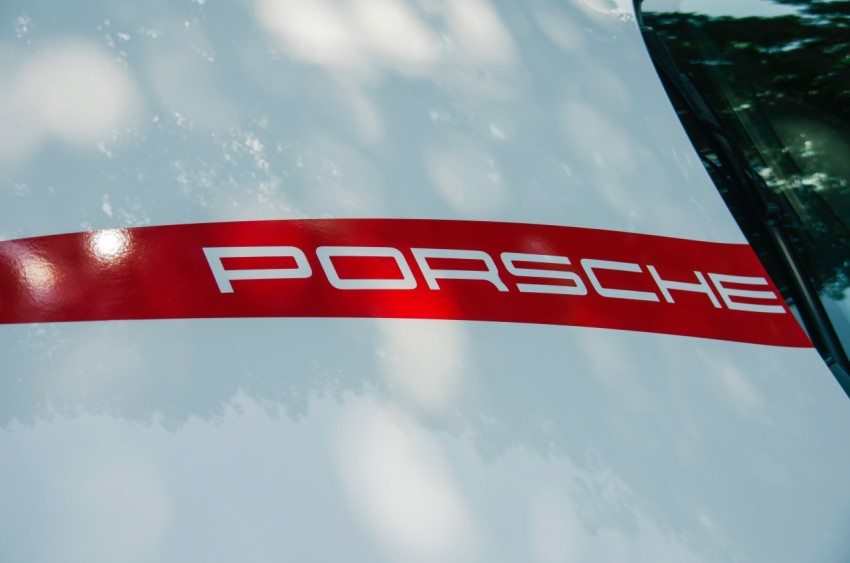 a close up of a porsche logo on the side of a car YUhoxw0