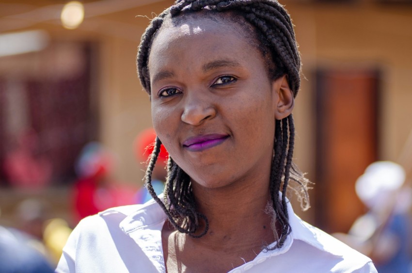 a close up of a person with braids