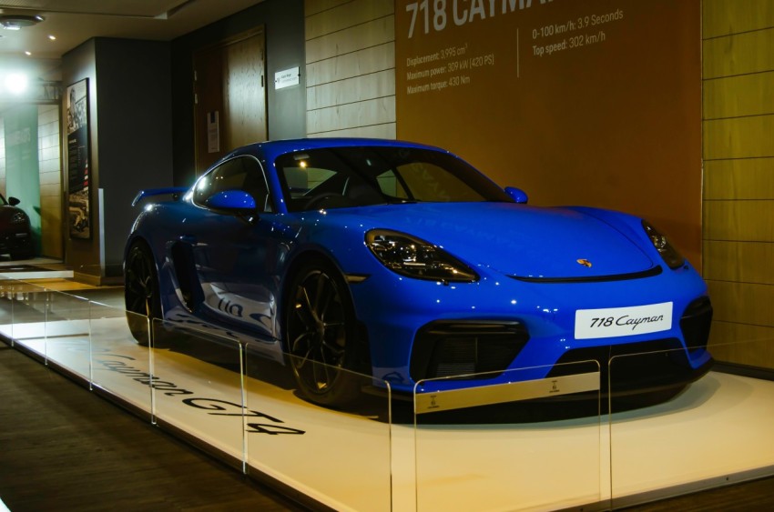 a blue sports car on display in a building