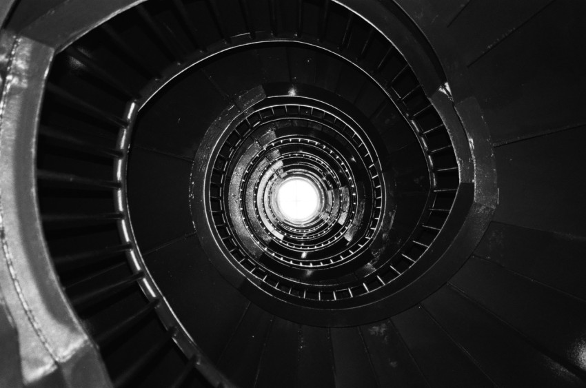 a black and white photo of a spiral staircase