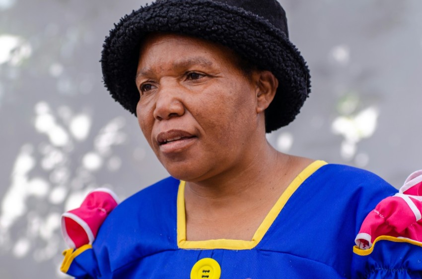 a woman wearing a blue shirt and a black hat