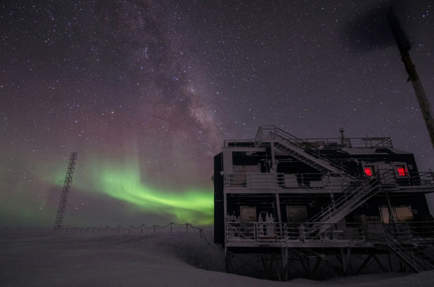 white multi storey building under starry night and northern lights