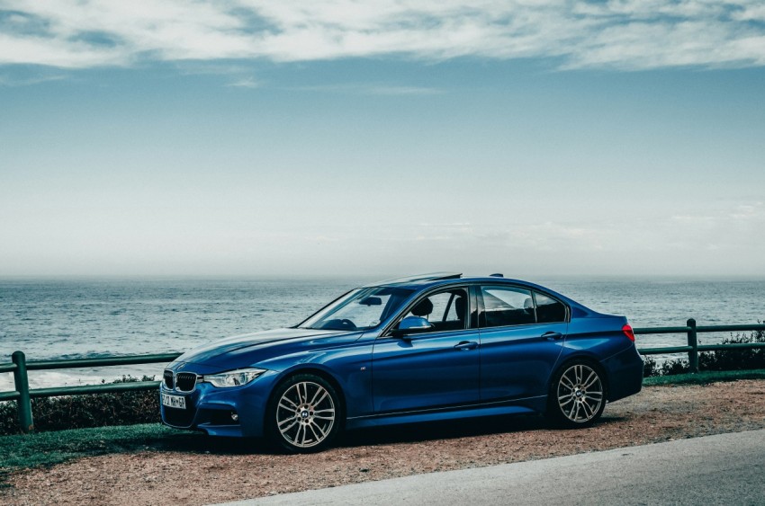 blue bmw m 3 coupe parked on seashore during daytime