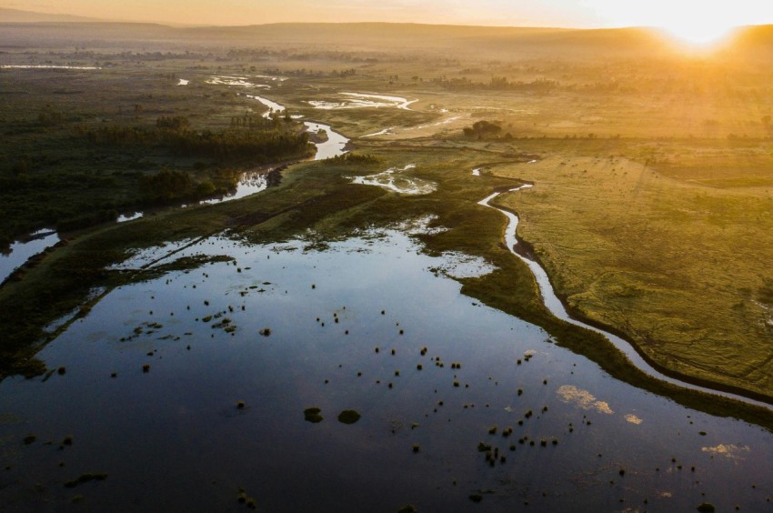 a river running through a lush green countryside
