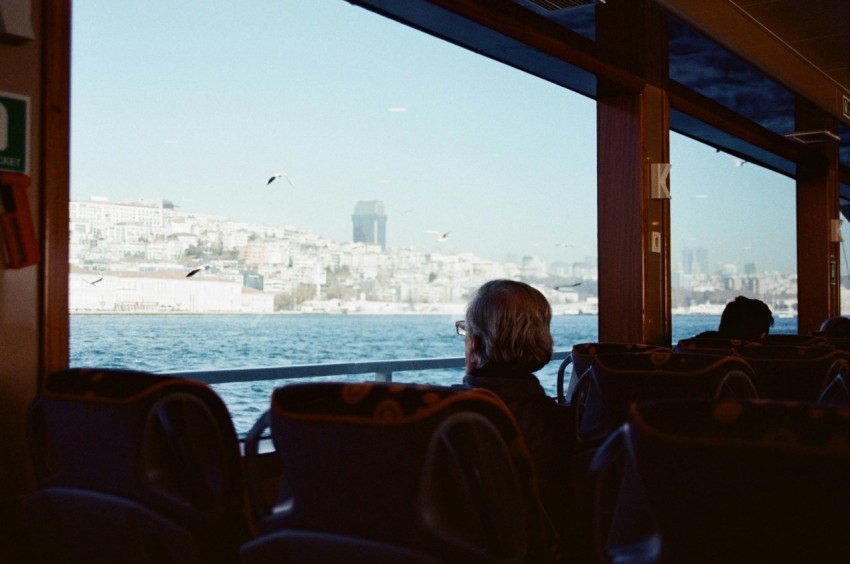 a man sitting on a bus looking out the window