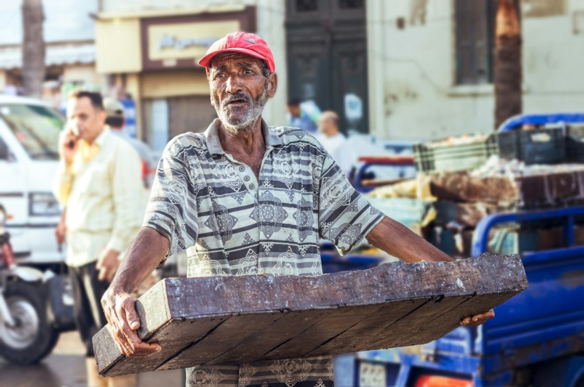 a man holding a large wheel QSVHv4No