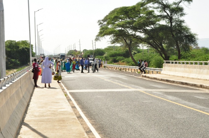 a group of people walking on a road