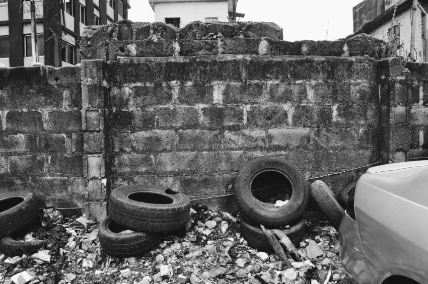 black car tire on gray concrete wall