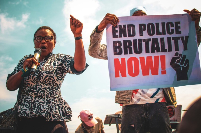 a person holding a sign and a microphone