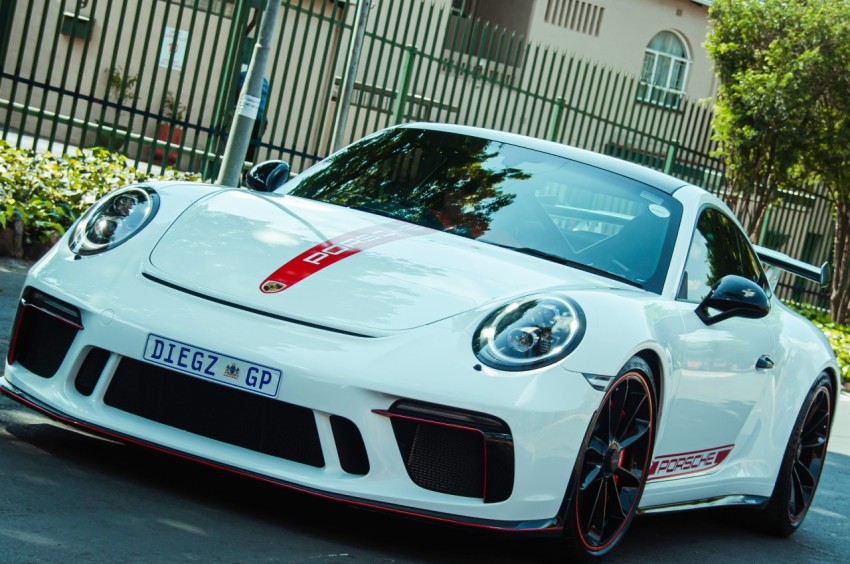 a white sports car parked on the side of the road