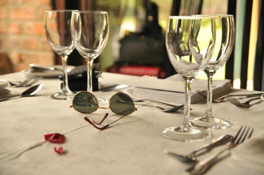 selective focus photography of clear long stem wine glasses on table