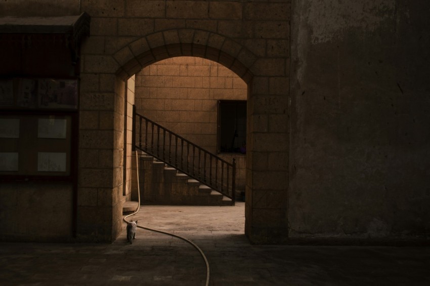 gray concrete hallway near gray concrete stairs