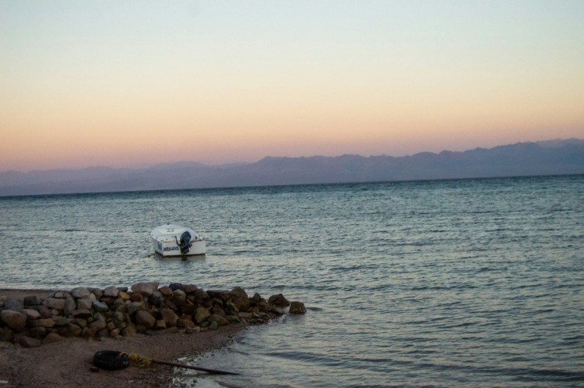 a small boat floating on top of a body of water