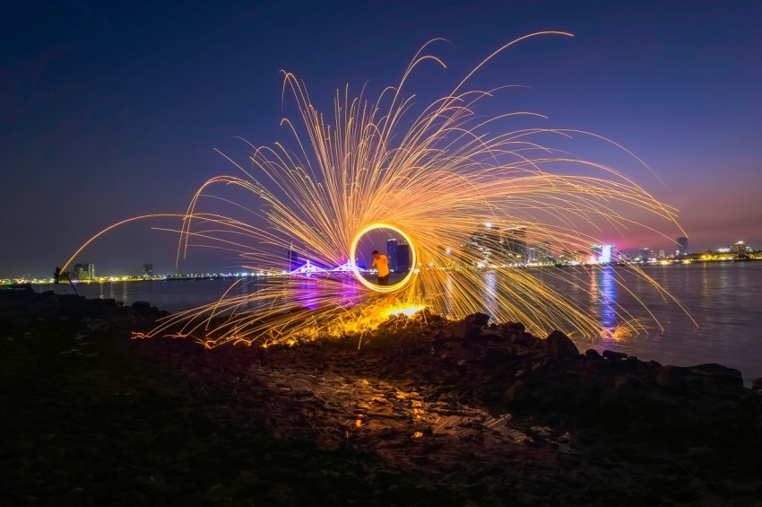 a firework display on the shore of a body of water MV