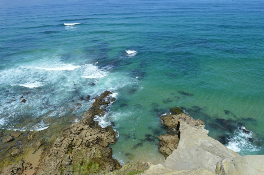 a view of the ocean from the top of a hill