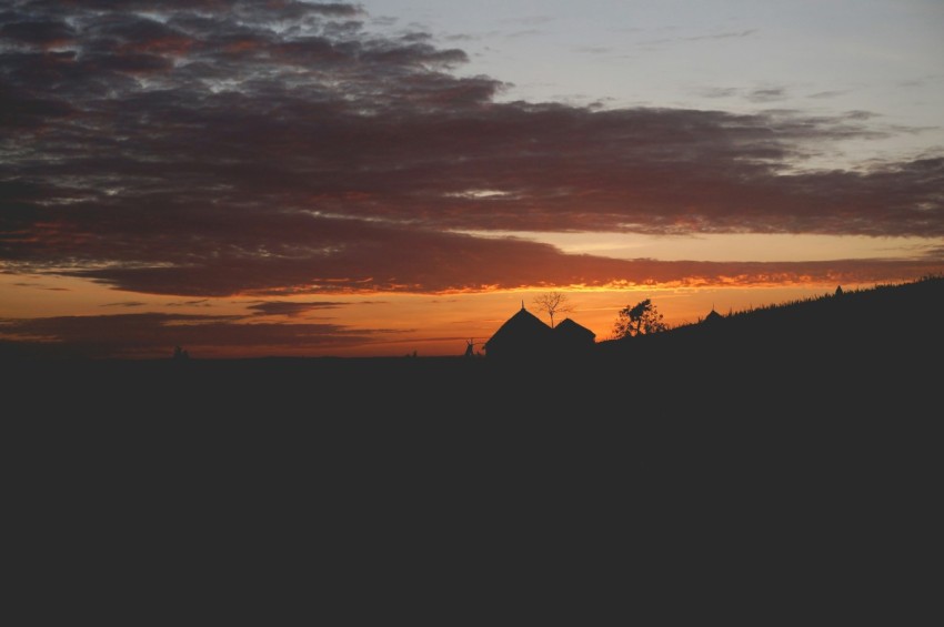 photo of silhouette of house during sunset