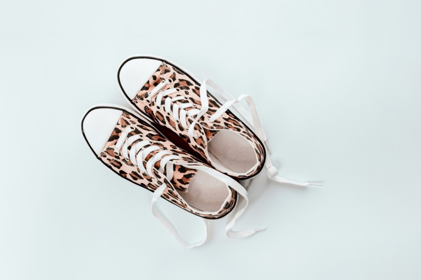 pair of brown and beige leopard print low top sneakers