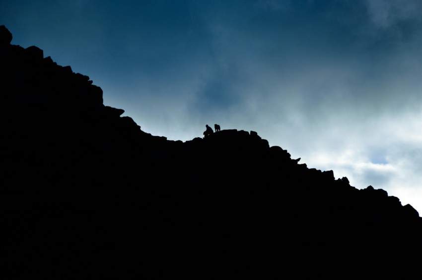 low angle of person on rock cliff P0J