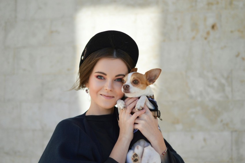 portrait photo of woman carrying puppy WrUGxeL