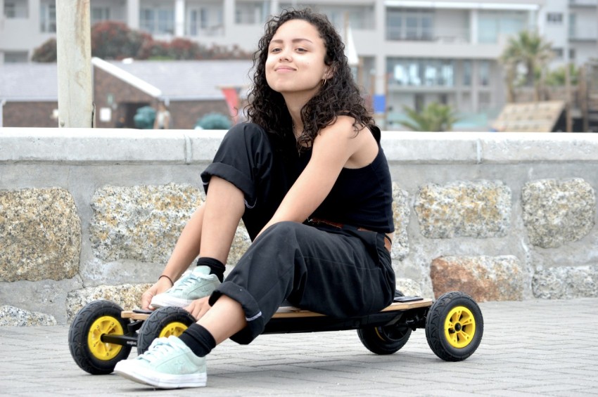 woman in black t shirt and blue denim shorts sitting on black wheel chair