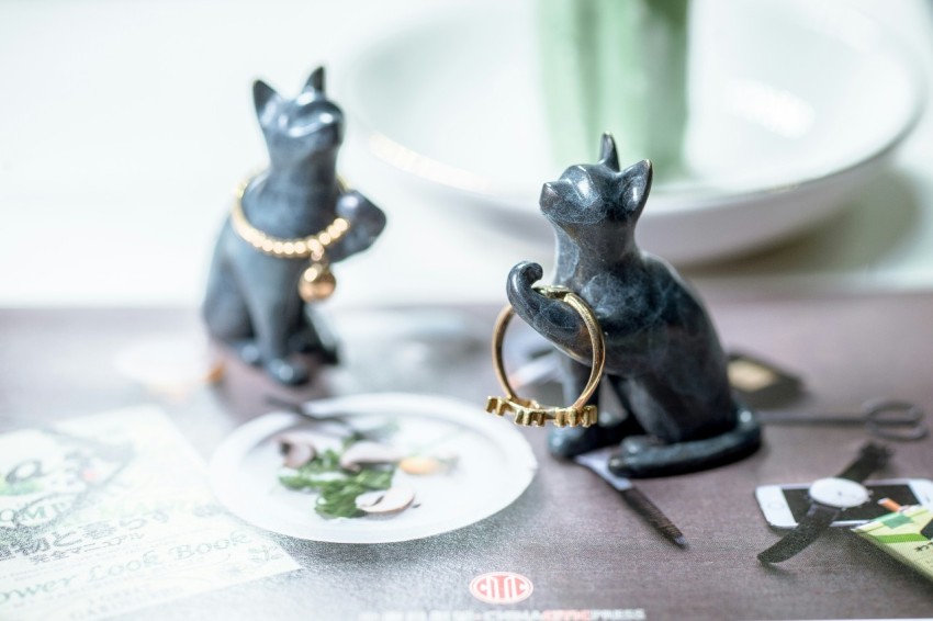 a couple of figurines sitting on top of a table