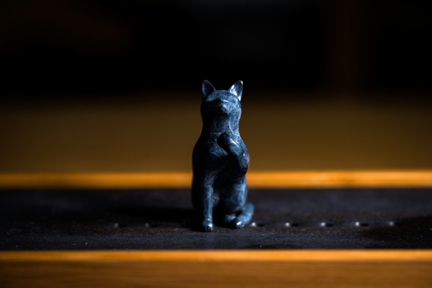 a small figurine of a cat on a table