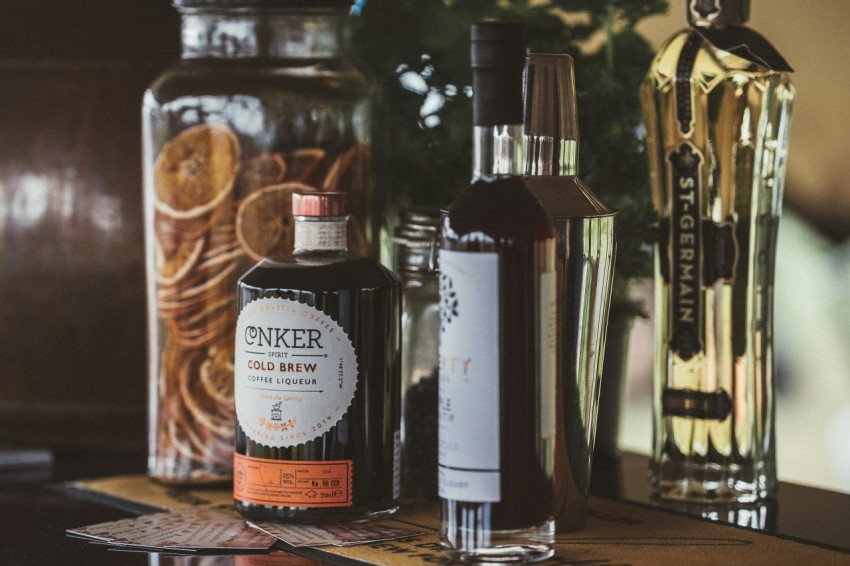 selective focus photo of two black and white labeled bottles