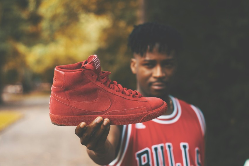 man showing red nike high top sneaker