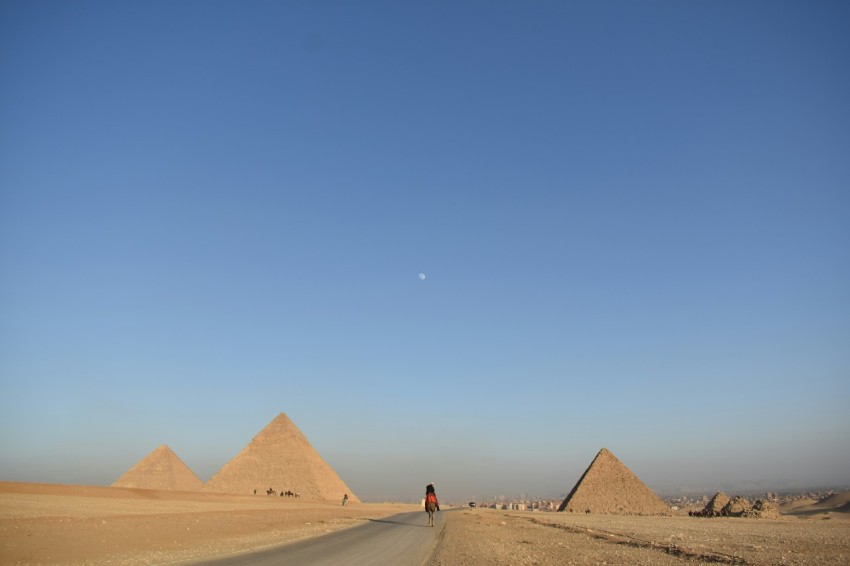 person walking near pyramids during daytime