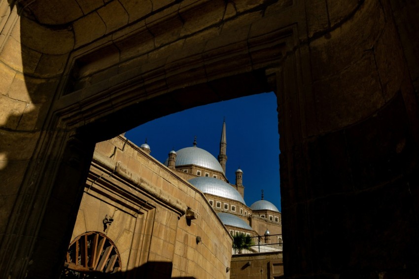 a view of a building through a hole in a wall