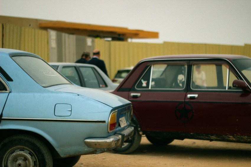 a blue car parked next to a red car