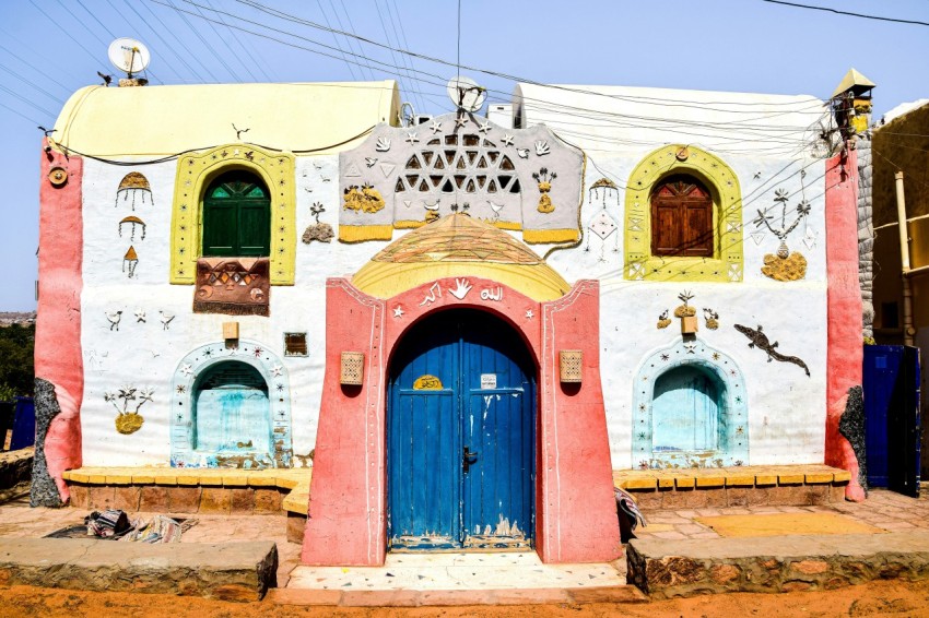 a colorfully painted building with a blue door