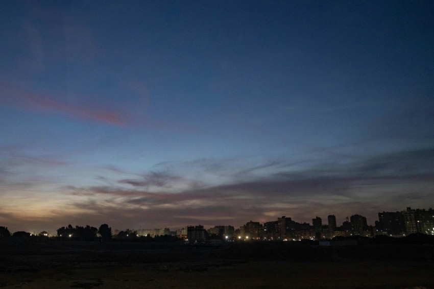 a view of a city at night from a beach