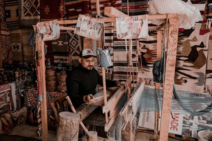 a man working on a weaving machine in a shop tj9KO