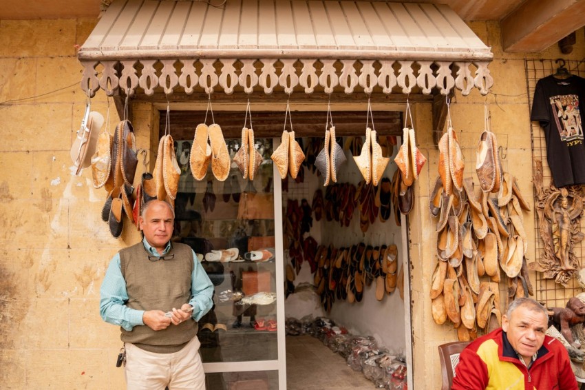 a couple of men standing in front of a store