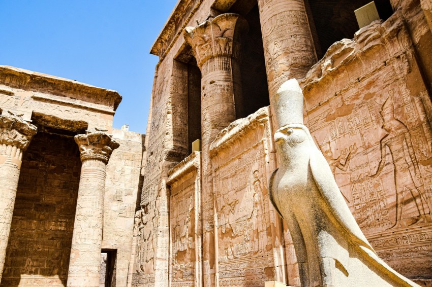 a stone building with a statue in front of it _