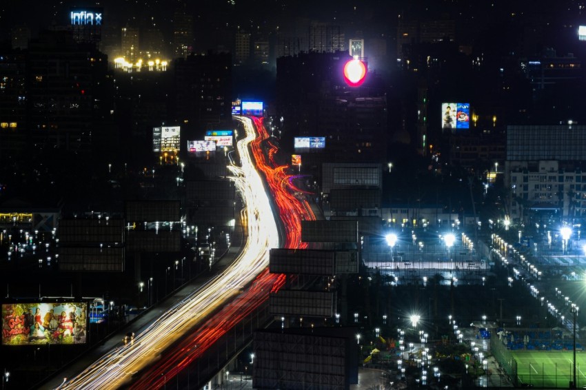 a city street at night with a red traffic light