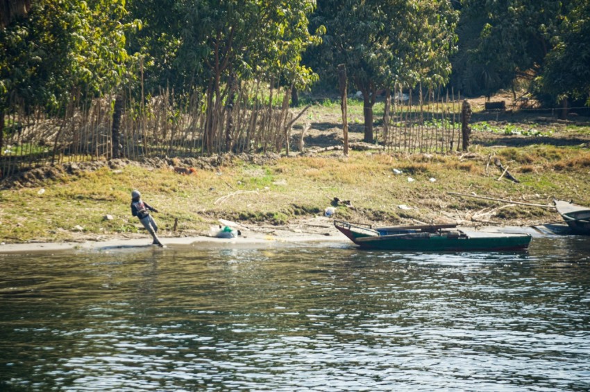 a couple of boats floating on top of a river