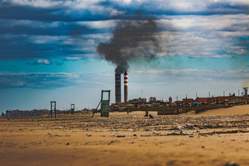 a factory with smoke coming out of its stacks