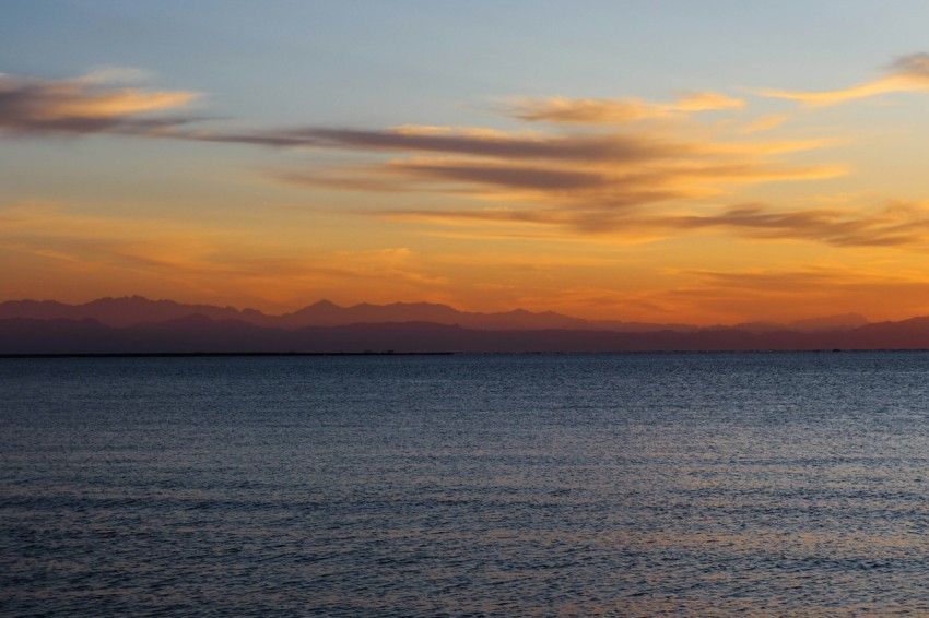 body of water during sunset