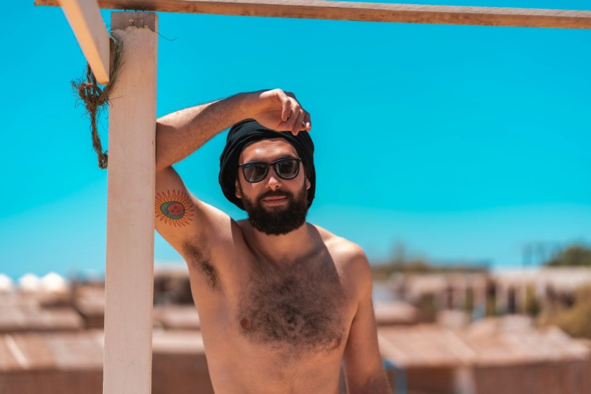 topless man wearing black goggles