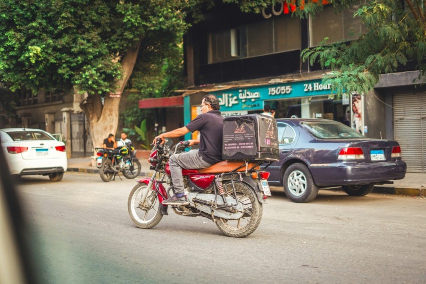 a man riding a motorcycle down a street