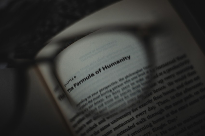 a close up of a book with a magnifying glass