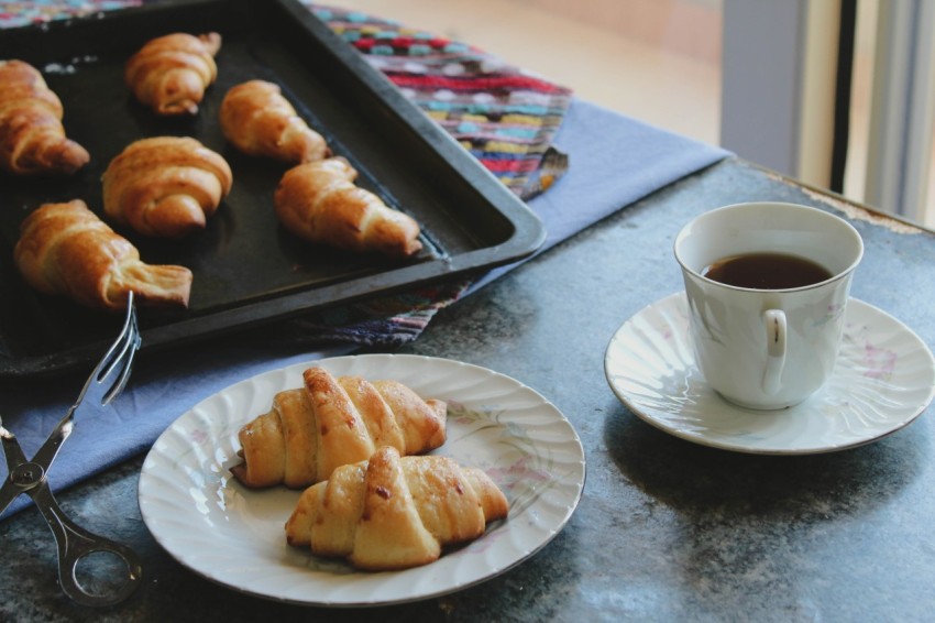 a plate of pastries and a cup of coffee a_sb