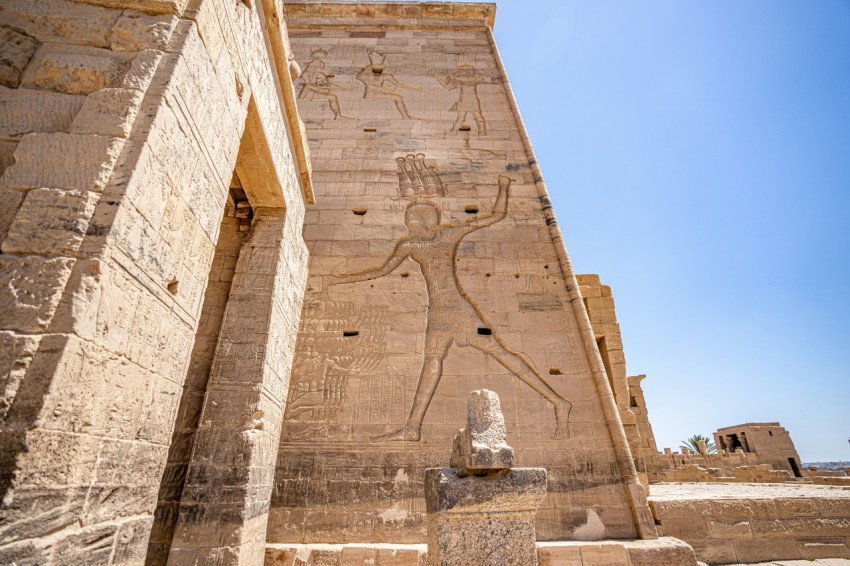 a stone building with a statue in front of it