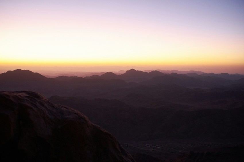 a sunset over a valley