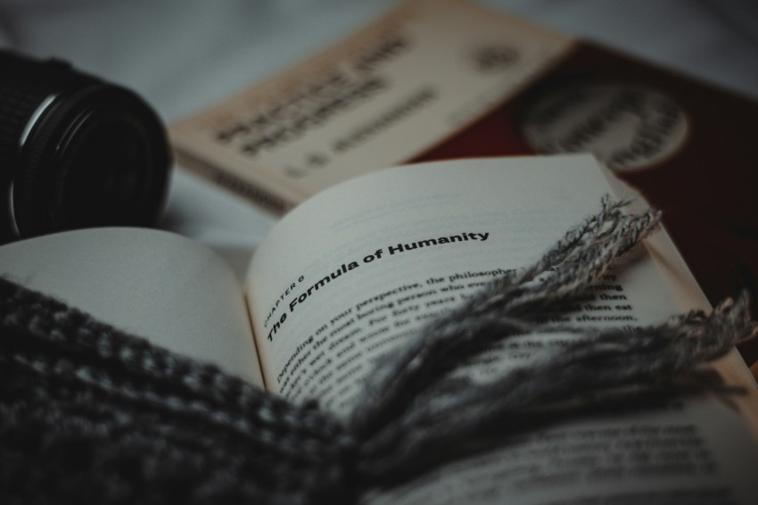 a close up of an open book on a bed GSj