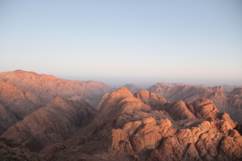 a view of a mountain range from the top of a hill