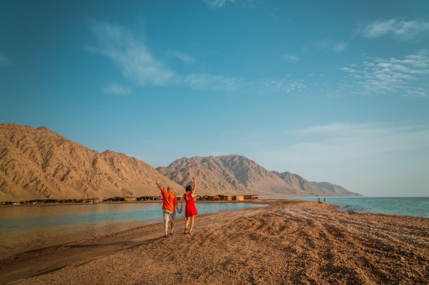 two person walking under blue sky