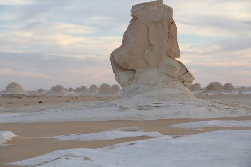 a large rock formation in the middle of a desert